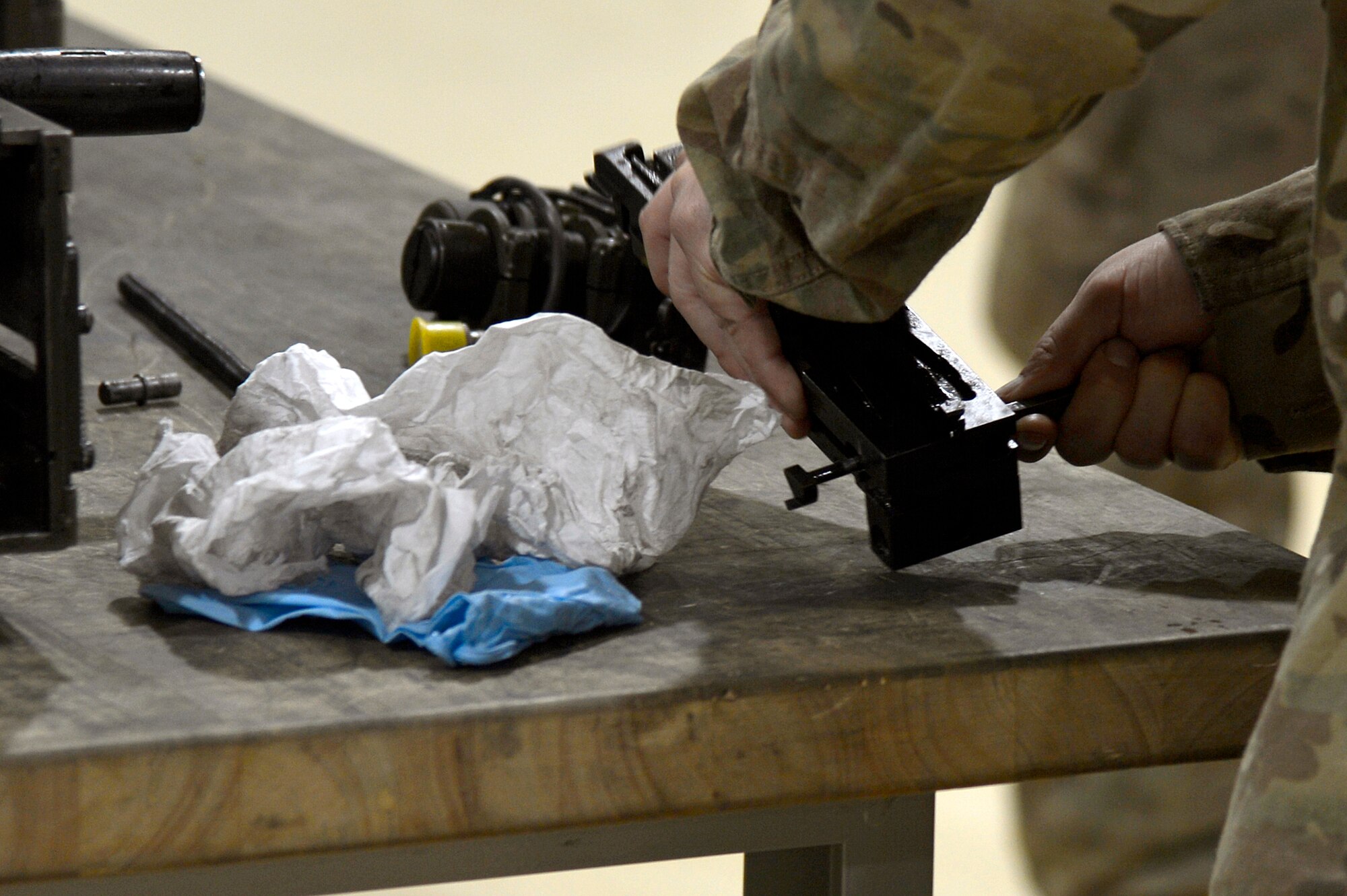 U.S. Air Force Tech. Sgt. Vincent Lopez, 83rd Expeditionary Rescue Squadron weapons expeditor, demonstrates putting together a GAU 18 machine gun at Bagram Airfield, Afghanistan, Jan. 19, 2014. Airmen assigned to the 455th Expeditionary Maintenance Squadron armament shop received training on the weapon systems of the HH-60G Pave Hawk from Lopez. Lopez is deployed from the 718th Aircraft Maintenance Squadron at Kadena Air Base, Japan, and is a native of El Paso, Texas. (U.S. Air Force photo by Senior Airman Kayla Newman/Released)