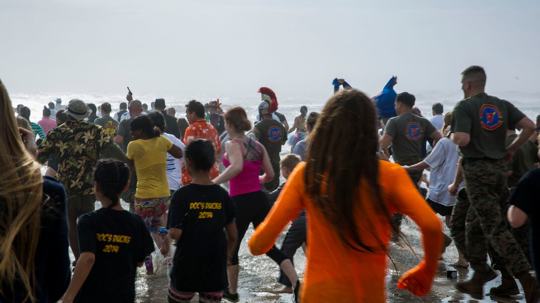 Participants sprint into the ocean during the 2014 Polar Plunge at Onslow Beach aboard Marine Corps Base Camp Lejeune, N.C., Jan. 11, 2014. (U.S. Marine Corps photo by Lance Cpl. Joshua Brown/Released)