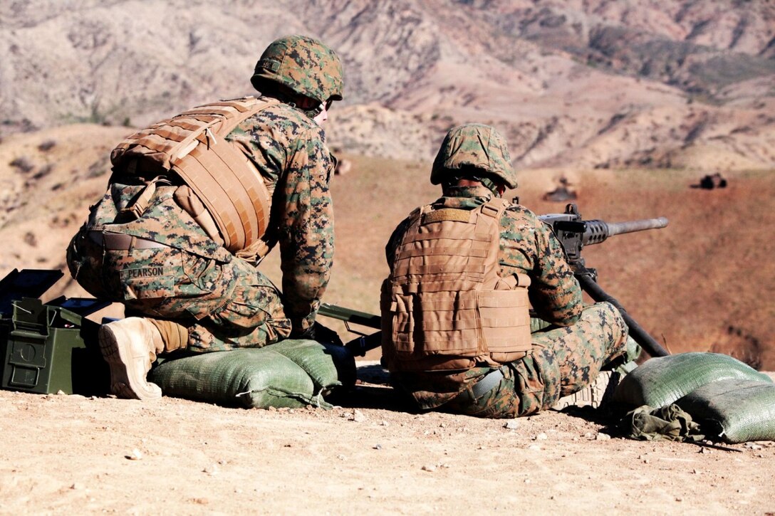 Lance Cpl. Ryan Pearson, a Marine with 1st Combat Engineer Battalion, tells the machine gunner which targets to aim for aboard Camp Pendleton, Calif., Jan. 15. The training was part of a two-week machine gunners course.