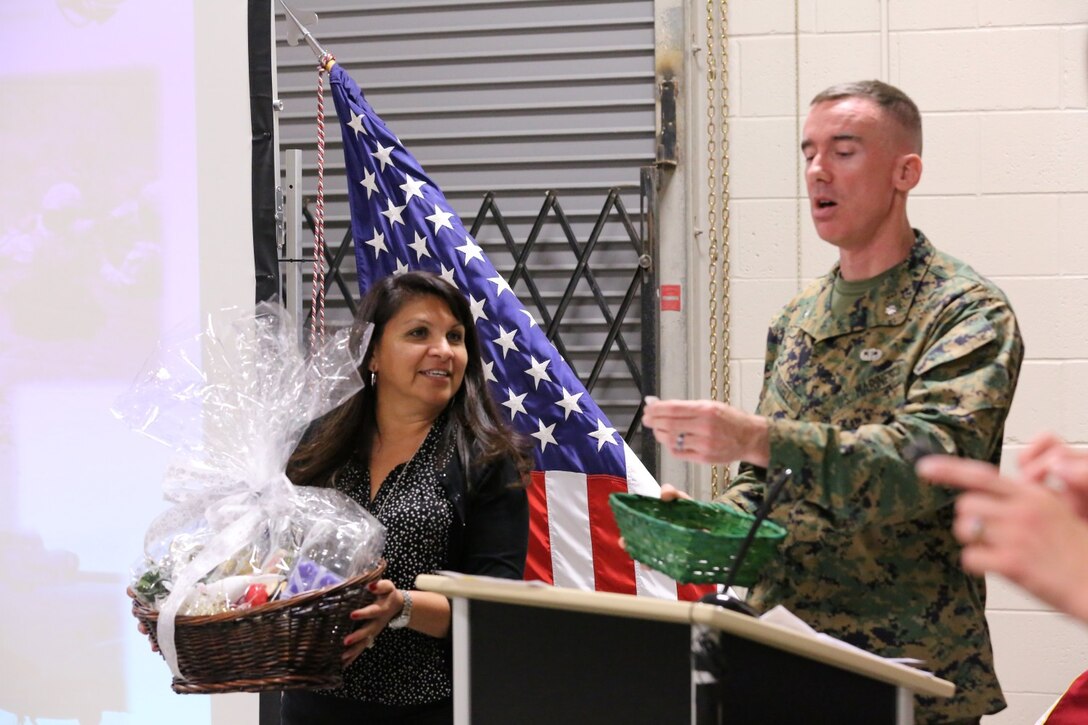 Lt. Col. Brian Russell, the commanding officer of 1st Air Naval Gunfire Liaison Company, and Missy Harrison, 1st ANGLICO’s family readiness officer, announce the winner of the raffle at a town hall meeting aboard Camp Pendleton, Calif., Jan 15. The meeting allowed families to ask questions and get a better sense of ANGLICO’s structure and purpose.