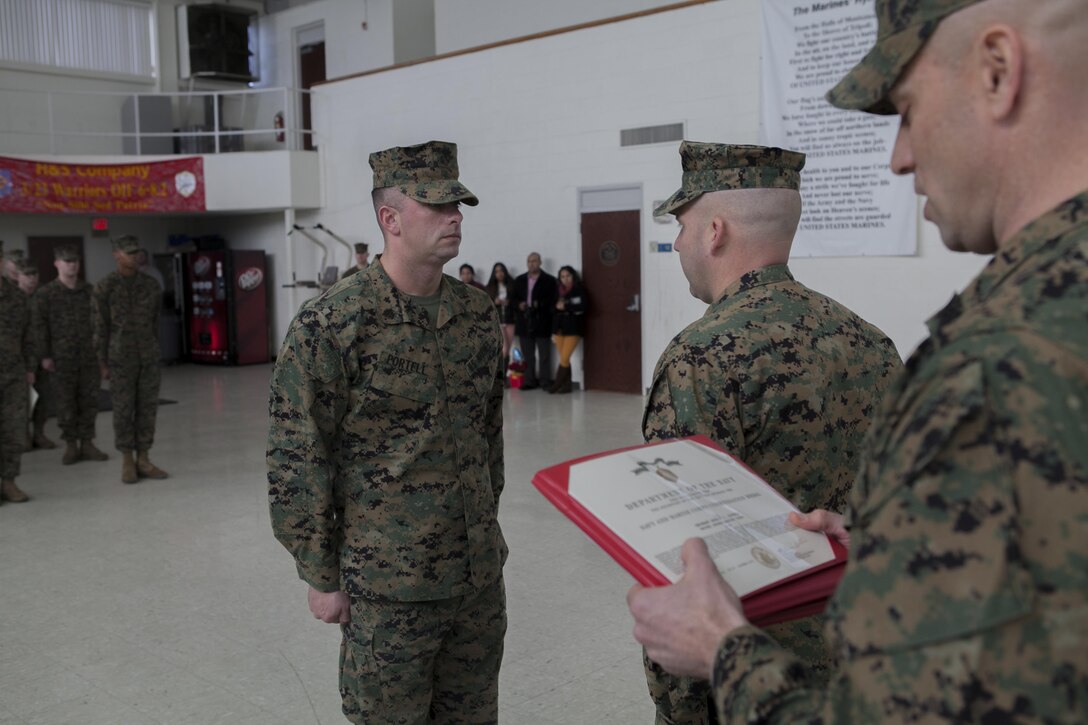 Sgt. Andrew Portell, funeral honors noncommissioned officer-in-charge, 3rd Battalion, 23rd Marine Regiment, is awarded the Navy and Marine Corps Commendation Medal at their home training center in Bridgeton, Mo., Jan 7. Portell received the award for his role in coordinating more than 1,000 funeral honors ceremonies, 623 of which he personally conducted. (U.S. Marine Corps photo by Sgt. Michael Ito)