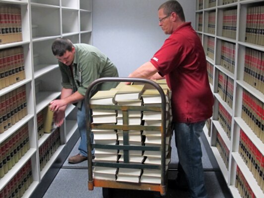 Huntsville Center's Logistics Office employees Robert McKibbin (left) and Jerry Roberts, Plexibuild Services, demonstrate proper use of material handling at organization Jan. 21.                   