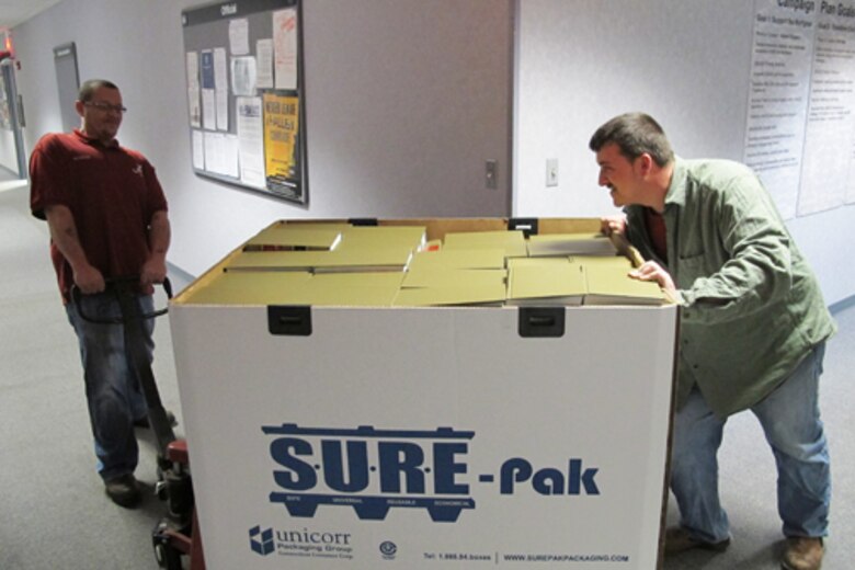Huntsville Center's Logistics Office employees Jerry Roberts (left) and Robert McKibbin, Plexibuild Services, demonstrate proper use of material handling at the organization Jan 21.                               