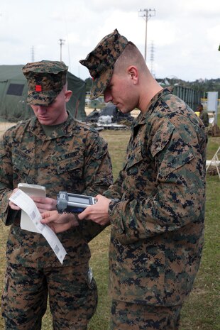 Lance Cpl. Nicholas Montgomery, left, executes an inventory review with Lance Cpl. Darrell W. Evans Jan. 15 at a command operations center training event at Camp Courtney. During the training, the Marines established a command operations center. Montgomery is a landing support specialist, and Evans is an airborne and air delivery specialist with Combat Logistics Regiment 37, 3rd Marine Logistics Group, III Marine Expeditionary Force.