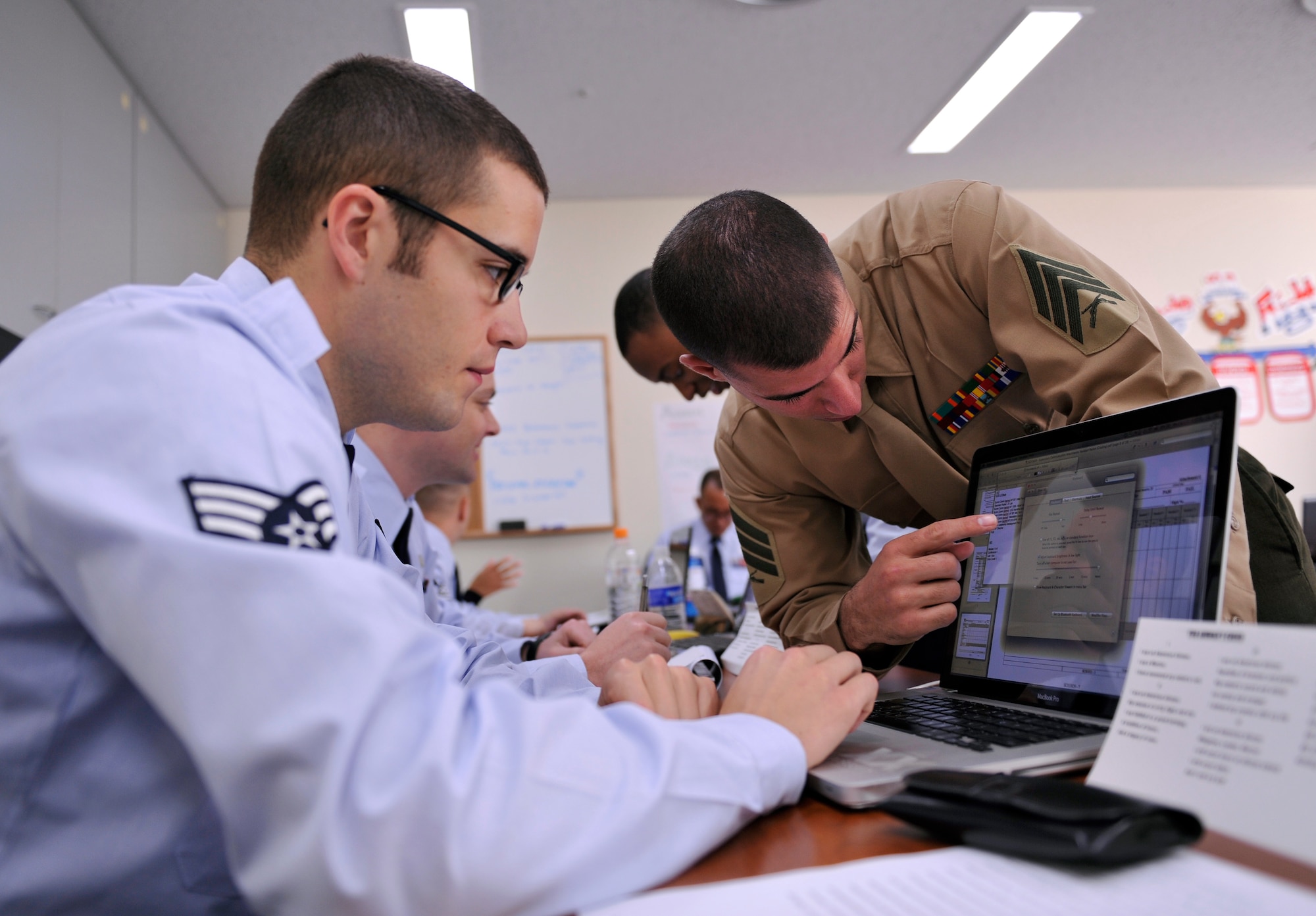U.S. Air Force Senior Airman Jason Reese, 718th Aircraft Maintenance Squadron crew chief, and U.S. Marine Corps Sgt. Steven Kern, Marine Corps Air Station Futenma 4th Platoon sergeant, work on a computer together during Airman Leadership School Class at the Erwin Professional Military Education Center on Kadena Air Base, Japan, Jan. 15, 2014. During ALS, students learn combat leadership skills, military professionalism, public speaking techniques and ways to lead by example. The Joint Professional Military Education brings in Marines and other service members to add depth and experience to the classroom discussions. (U.S. Air Force photo by Naoto Anazawa)

