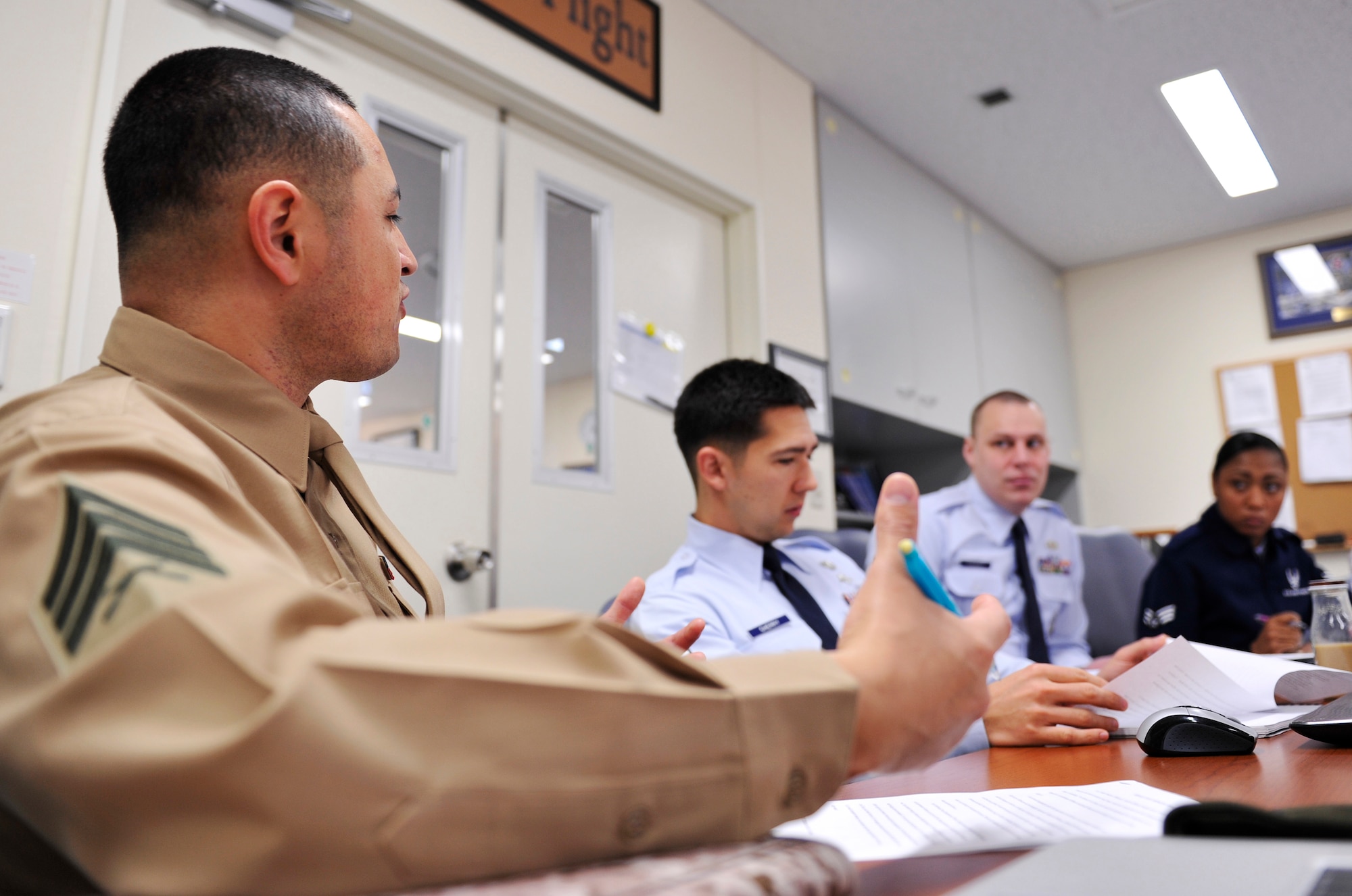 U.S. Marine Corps Sgt. Alejandro Aguilar, Marine Corps Air Station Futenma 4th Maintenance chief, discusses leadership skills with other Airmen Leadership School students at the Erwin Professional Military Education Center on Kadena Air Base, Japan, Jan. 15, 2014. ALS is a five-week long program designed to educate Air Force senior airmen and staff sergeants and develop effective and efficient NCOs and leaders. The classroom discussion benefits Airmen as well as Marines. (U.S. Air Force photo by Naoto Anazawa)