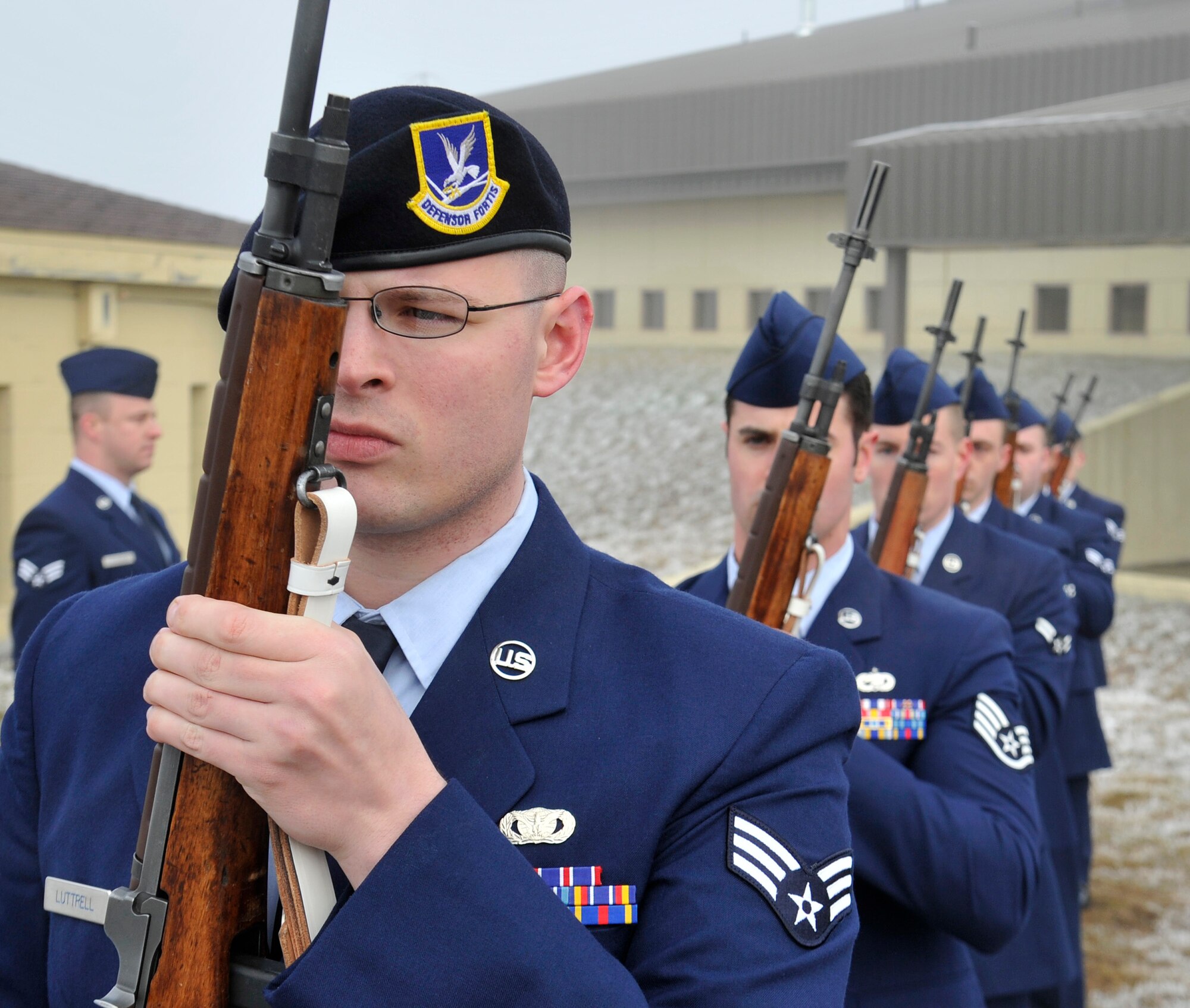 Senior Airman Casey Luttrell, 92nd Security Forces Squadron, holds a ceremonial rifle at port arms during the Honor Guard graduation ceremony at Fairchild Air Force Base, Wash., Jan. 17, 2014. Honor guard trainees fire a three-volley rifle salute in a simulated 21-gun salute during their graduation. The three shots signify duty, honor and country. (U.S. Air Force photo by Airman 1st Class Ryan Zeski/Released)