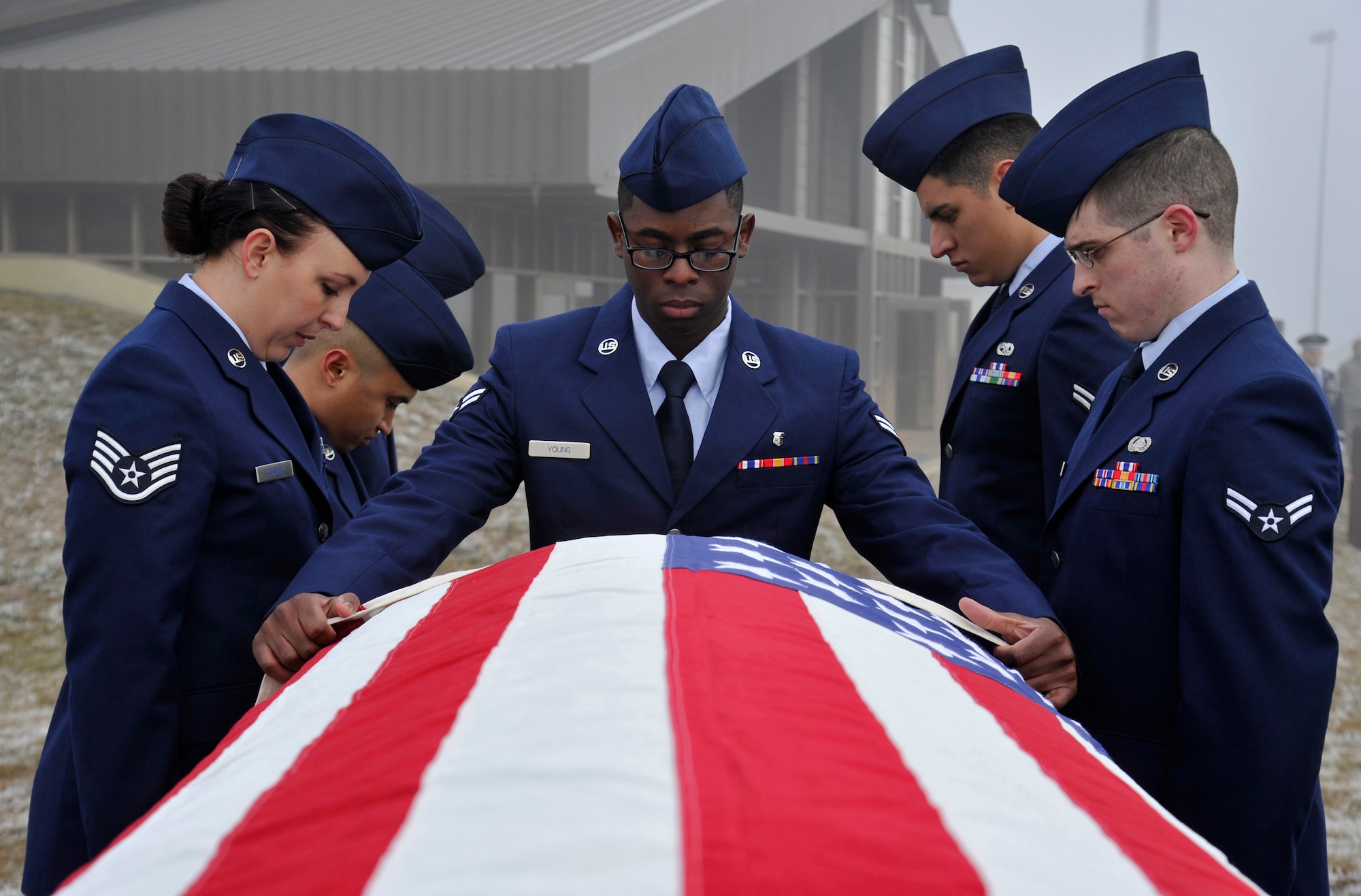 Airman 1st Class Garrett Young, 92nd Medical Dental Squadron, simulates pulling a casket out of a hearse during the Honor Guard graduation ceremony at Fairchild Air Force Base, Wash., Jan. 17, 2014. Airmen practice their technique multiple times to ensure they are prepared for a live ceremony. (U.S. Air Force photo by Airman 1st Class Ryan Zeski/Released)