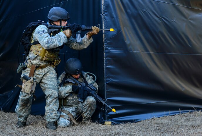 Airmen from the 1st, 2nd and 3rd Combat Camera Squadrons provide security during the Ability to Survive and Operate exercise Jan. 14, 2014, at North Auxiliary Air Field, S.C. The exercise was organized to sharpen Airmen’s skills and their ability to operate as combat documentation specialists outside the wire. (U.S. Air Force photo/ Airman 1st Class Clayton Cupit)