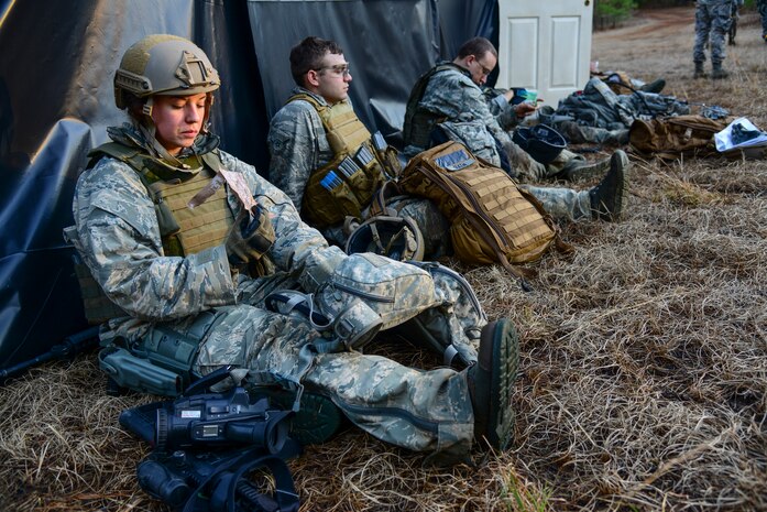 Airmen from the 1st, 2nd and 3rd Combat Camera Squadrons take a break to eat during the Ability to Survive and Operate exercise Jan. 14, 2014, at North Auxiliary Air Field, S.C. The exercise was organized to sharpen Airmen’s skills and their ability to operate as combat documentation specialists outside the wire. (U.S. Air Force photo/ Airman 1st Class Clayton Cupit)