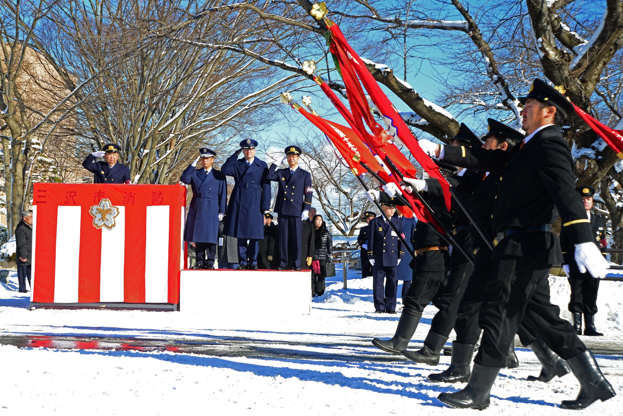 Misawa City Mayor Kazumasa Taneichi, Japan Air Self-Defense Forces Maj. Gen. Tamotsu Kidono, 3rd Air Wing commander, U.S. Air Force Col. Stephen Williams, 35th Fighter Wing commander, and Vice Mayor Koichiro Maita, salute as firefighters and volunteers’ parade by Jan. 19, 2014. Firefighters from Misawa Air Base and Misawa City display their pride to their community by holding a parade around the city center. (U.S. Air Force photo by Tech. Sgt. April Quintanilla)