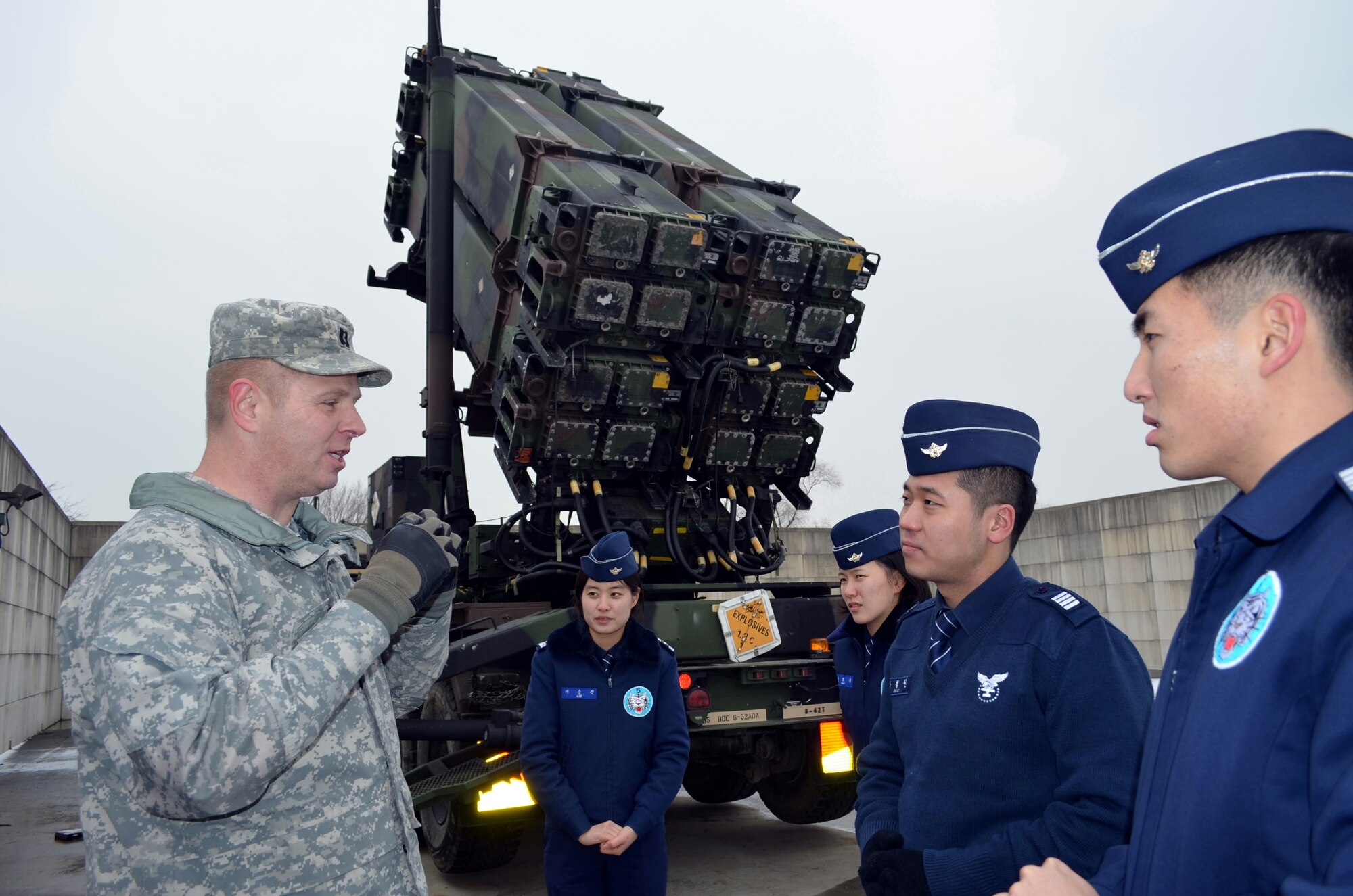 Capt. Edward Ellingson, 35th Air Defense Artillery Brigade public affairs officer, explains the U.S. Patriot missile system to Republic of Korea Air Force cadets at Osan Air Base, ROK, January 21, 2014. Nearly 100 cadets attended the trip to learn about the U.S. Patriot missile and Army air defense. (U.S. Army photo/Staff Sgt. Heather A. Denby)
