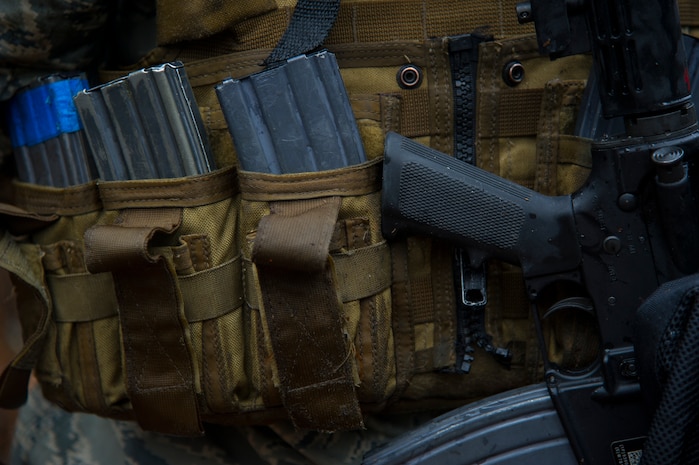 Airmen from the 1st, 2nd and 3rd Combat Camera Squadrons wear combat vests with magazines and other combat equipment needed during the Ability to Survive and Operate exercise Jan. 14, 2014, at North Auxiliary Air Field, S.C. The exercise was organized to sharpen Airmen’s skills and their ability to operate as combat documentation specialists outside the wire. (U.S. Air Force photo/ Airman 1st Class Clayton Cupit)