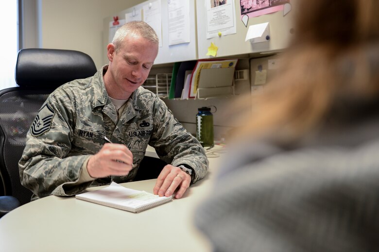 Master Sgt. Phil Ryan, 62nd Airlift Wing Inspector General complaint resolution superintendent, takes notes in his office, Jan. 17, 2014, at Joint Base Lewis-McChord, Wash. Ryan, also a reserve police officer with the Yelm Police Department in Yelm, Wash., applies the investigation skills he has learned as a police officer in his position in the 62nd AW IG office. (U.S. Air Force photo/Tech. Sgt. Sean Tobin)