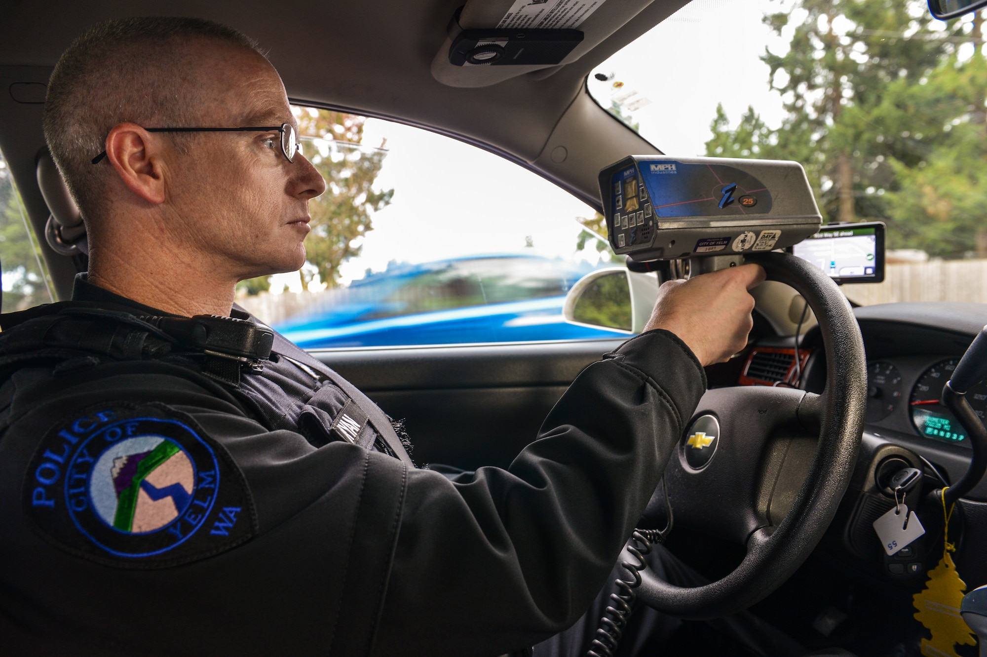 Master Sgt. Phil Ryan, 62nd Airlift Wing Inspector General complaint resolution superintendent, also a reserve police officer at the Yelm Police Department, monitors drivers' speed with a radar detector, Dec. 14, 2013, in Yelm, Wash. Ryan has more approximately 800 hours experience as a volunteer police officer. (U.S. Air Force photo/Tech. Sgt. Sean Tobin)