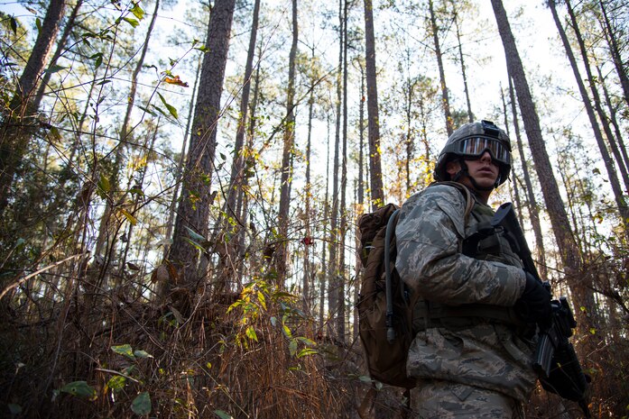 Staff Sgt. Johnathon Snyder, 3rd Combat Camera photojournalist, provides rear security during the Ability to Survive and Operate exercise Jan. 17, 2014, at North Auxiliary Air Field, S.C. The exercise was organized to sharpen Airmen’s skills and their ability to operate as combat documentation specialists outside the wire. (U.S. Air Force photo/ Airman 1st Class Clayton Cupit)