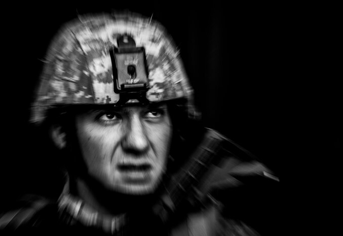 Senior Airman Gregory Cerny, 1st Combat Camera Squadron broadcaster, takes cover behind a wall while enemy forces fires attack his team with small arms fire during the Ability to Survive and Operate exercise Jan. 14, 2014, at North Auxiliary Air Field, S.C. The 1st Combat Camera Squadron located at Joint Base Charleston, S.C., hosted the Ability to Survive and Operate Exercise from Jan. 6 through 17. (U.S. Air Force photo/ Senior Airman Dennis Sloan)