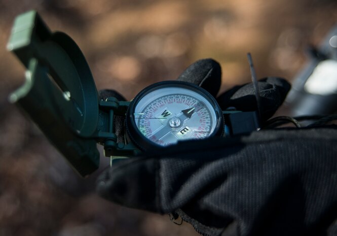 Senior Airman Gregory Cerny, 1st Combat Camera Squadron broadcaster, uses a compass to navigate his team in the right direction during the Ability to Survive and Operate exercise Jan. 14, 2013, at North Auxiliary Air Field, S.C. The 1st Combat Camera Squadron located at Joint Base Charleston, S.C., hosted the Ability to Survive and Operate Exercise from Jan. 6 through 17. (U.S. Air Force photo/ Senior Airman Dennis Sloan)