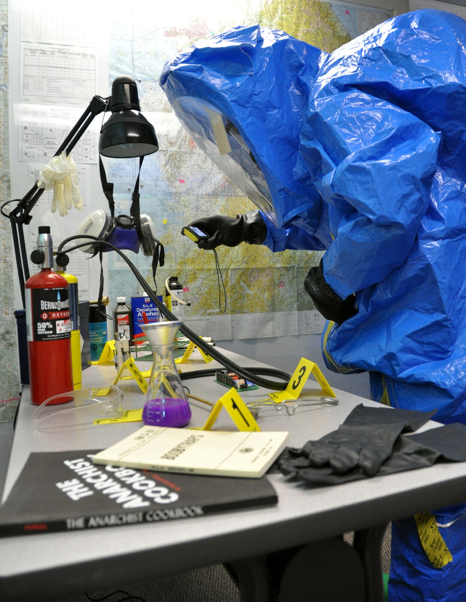 Senior Airman Aaron Wentland, 60th Civil Engineer Squadron emergency management plans and operations specialist, documents evidence at a simulated crime scene in an exercise scenario Monday on Travis.(U.S. Air Force photo/Staff Sgt. Patrick Harrower)