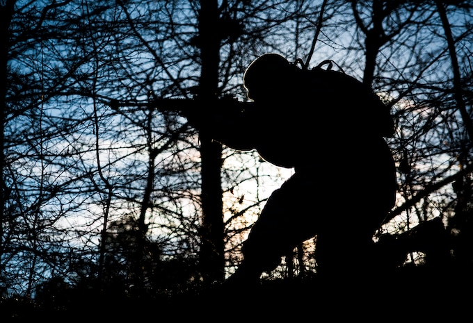 Senior Airman Daniel Hughes, 1st Combat Camera Squadron photojournalist, aims his M-4 carbine Rifle towards a simulated enemy convoy  during the Ability to Survive and Operate exercise Jan. 15, 2014, at North Auxiliary Air Field, S.C. The 1st Combat Camera Squadron located at Joint Base Charleston, S.C., hosted the Ability to Survive and Operate Exercise from Jan. 6 through 17. (U.S. Air Force photo/ Senior Airman Dennis Sloan)