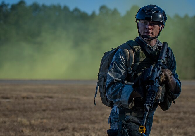 Senior Airman Eric Mann, 1st CTCS broadcaster, sprints across a field during the Ability to Survive and Operate exercise Jan. 14, 2014, at North Auxiliary Air Field, S.C. The exercise was organized to sharpen Airmen’s skills and their ability to operate as combat documentation specialists outside the wire. (U.S. Air Force photo/ Airman 1st Class Clayton Cupit)