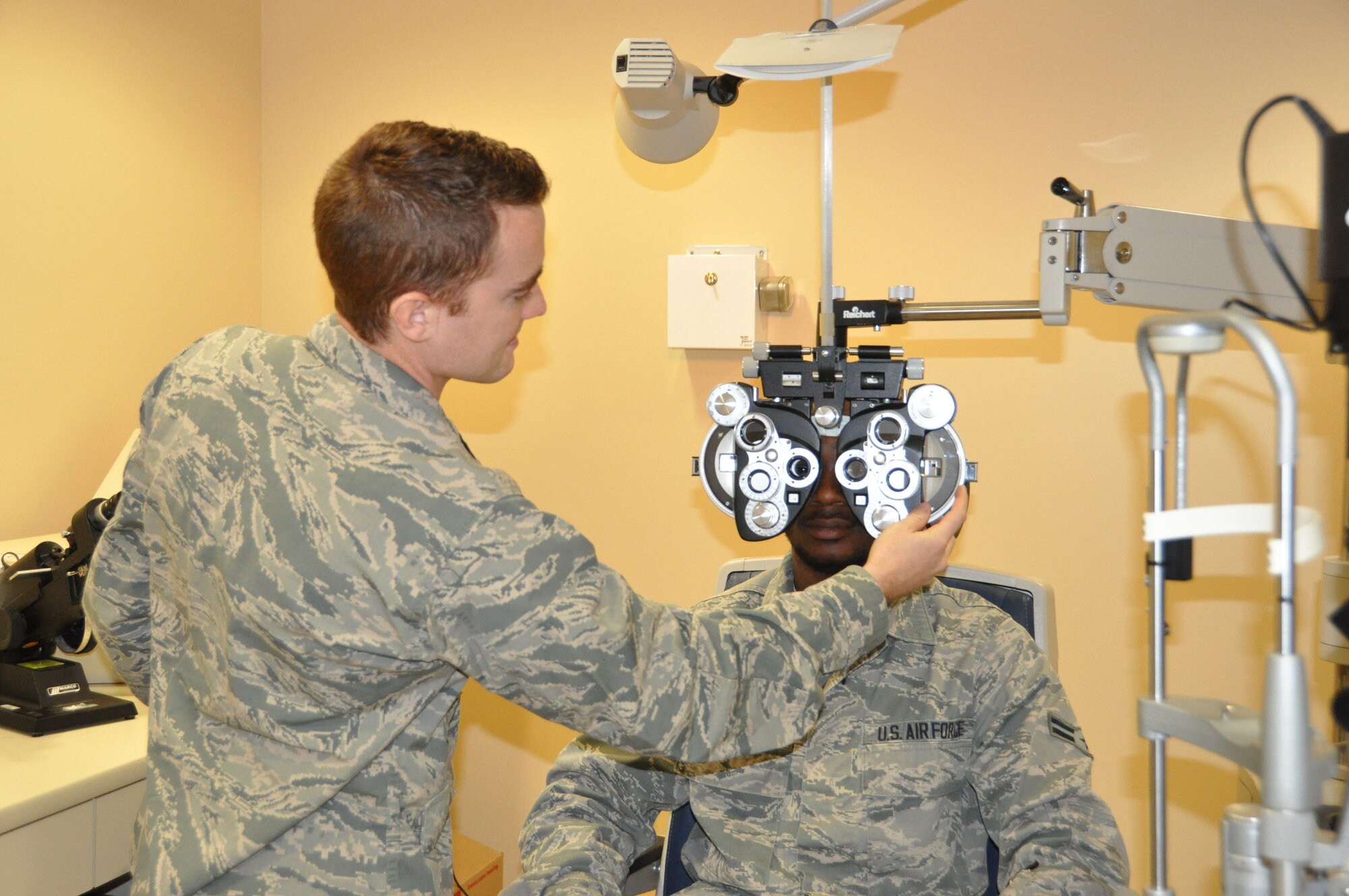 Capt. Nicholas Jones, 60th Aerospace Medicine Squadron optometry flight staff optometrist, conducts an eye examination last month at the optometry clinc at David Grant USAF Medical Center.