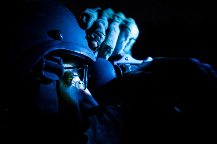 Staff Sgt. Michelle DeMers, 1st Combat Camera Squadron broadcaster, has her night vision goggles adjusted by Tech. Sgt. DeNoris Mickle, 1st CTCS photo element lead, before heading out on a night patrol during the Ability to Survive and Operate exercise Jan. 14, 2014, at North Auxiliary Air Field, S.C. The 1st Combat Camera Squadron located at Joint Base Charleston, S.C., hosted the Ability to Survive and Operate Exercise from Jan. 6 through 17. (U.S. Air Force photo/ Senior Airman Dennis Sloan)