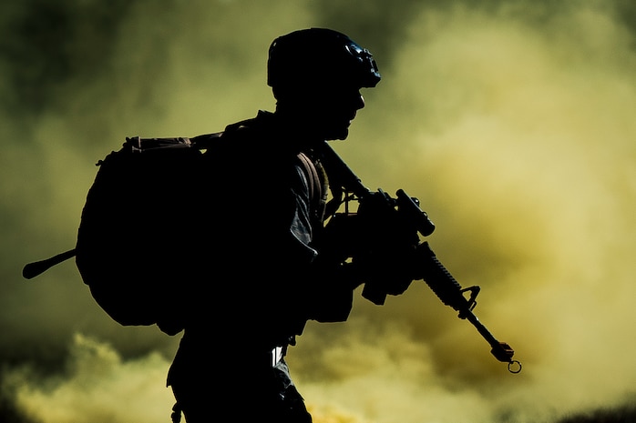 Senior Airman Eric Mann, 1st Combat Camera Squadron broadcaster, runs through smoke used to provide cover as he and his team cross a field during the tactical portion of the Ability to Survive and Operate exercise Jan. 14, 2014, at North Auxiliary Air Field, S.C. The 1st Combat Camera Squadron located at Joint Base Charleston, S.C., hosted the Ability to Survive and Operate Exercise from Jan. 6 through 17. (U.S. Air Force photo/ Senior Airman Dennis Sloan)