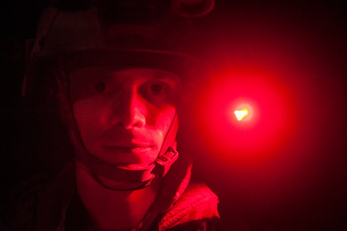 Staff Sgt. Devin Long, 628th Civil Engineer Squadron explosive ordnance disposal technician, wears a red light on his helmet to navigate through the woods at night and to prevent blinding individuals wearing night vision goggles during the night tactical portion of the Ability to Survive and Operate exercise Jan. 14, 2014, at North Auxiliary Air Field, S.C. Airmen from the EOD flight made battle and Improvised Explosive Devise scenarios as real as possible and provided oversight during the training. (U.S. Air Force photo/ Senior Airman Dennis Sloan)