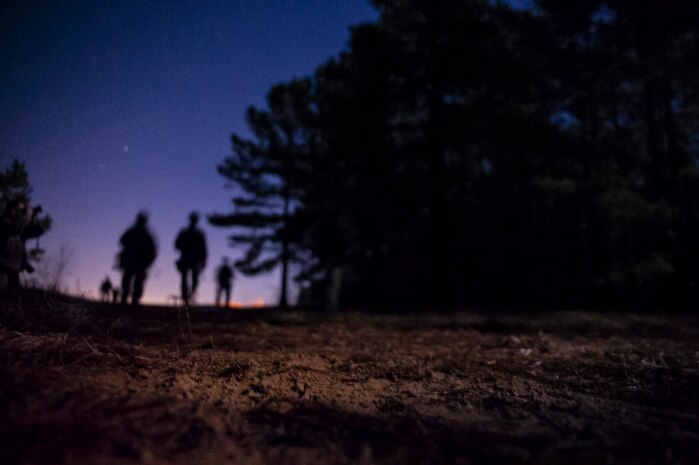 Airmen from the 1st, 2nd and 3rd Combat Camera Squadrons patrol the roads at night during the Ability to Survive and Operate exercise Jan. 14, 2014, at North Auxiliary Air Field, S.C. The exercise was organized to sharpen Airmen’s skills and their ability to operate as combat documentation specialists outside the wire. (U.S. Air Force photo/ Airman 1st Class Clayton Cupit)