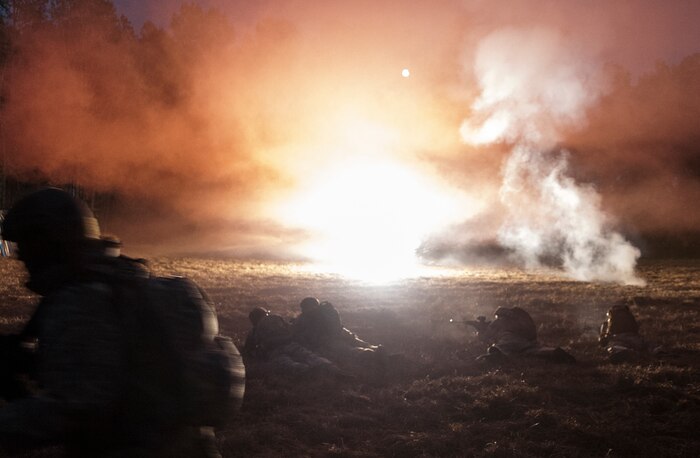 Airmen from the 1st, 2nd and 3rd Combat Camera Squadrons come under heavy fire with simulated explosions during the tactical portion of the Ability to Survive and Operate exercise Jan. 14, 2014, at North Auxiliary Air Field, S.C. The 1st Combat Camera Squadron located at Joint Base Charleston, S.C., hosted the Ability to Survive and Operate Exercise from Jan. 6 through 17. (U.S. Air Force photo/ Senior Airman Dennis Sloan)