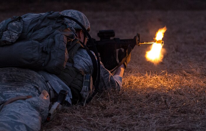 Senior Airman Gregory Cerny, 1st Combat Camera Squadron broadcaster, fires at opposing forces during the Ability to Survive and Operate exercise Jan. 14, 2014, at North Auxiliary Air Field, S.C. The 1st Combat Camera Squadron located at Joint Base Charleston, S.C., hosted the Ability to Survive and Operate Exercise from Jan. 6 through 17. (U.S. Air Force photo/ Airman 1st Class Clayton Cupit)
