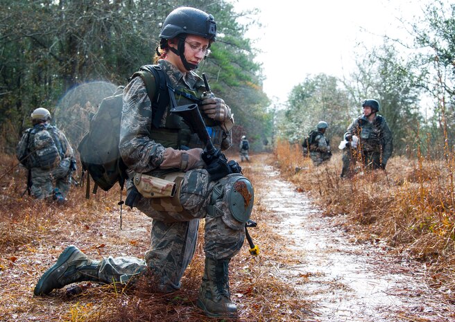 Staff Sgt. Michelle DeMers, 1st Combat Camera Squadron broadcaster, communicates over the radio to her team during the Ability to Survive and Operate exercise Jan. 14, 2014, at North Auxiliary Air Field, S.C. The exercise was organized to sharpen Airmen’s skills and their ability to operate as combat documentation specialists outside the wire. (U.S. Air Force photo/ Airman 1st Class Clayton Cupit)