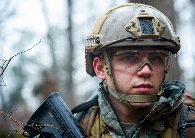 Airman Taylor Queen, 2nd Combat Camera Squadron photojournalist, provides security during the Ability to Survive and Operate exercise Jan. 14, 2014, at North Auxiliary Air Field, S.C. The 1st Combat Camera Squadron located at Joint Base Charleston, S.C., hosted the Ability to Survive and Operate Exercise from Jan. 6 through 17.(U.S. Air Force photo/ Airman 1st Class Clayton Cupit)
