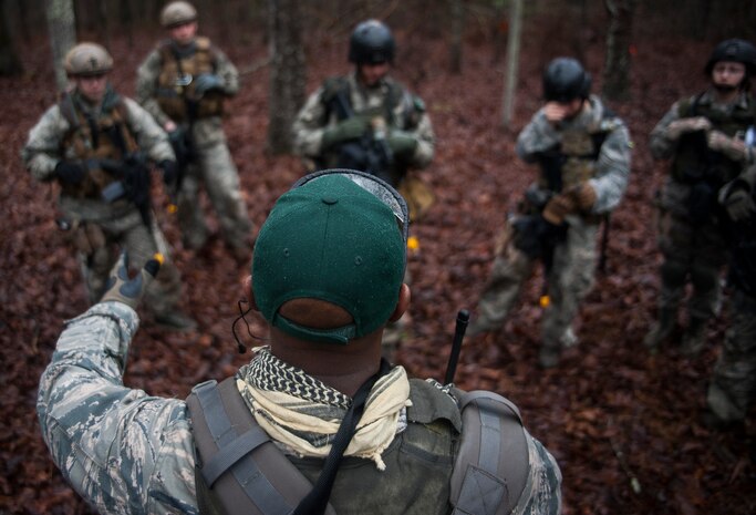 Tech. Sgt. DeNoris Mickle, 1st Combat Camera Squadron photo element lead, speaks with a team of combat documentation specialists comprised of Airmen from the 1st, 2nd and 3rd CTCS during the tactical portion of the Ability to Survive and Operate exercise Jan. 14, 2014, at North Auxiliary Air Field, S.C. The 1st Combat Camera Squadron located at Joint Base Charleston, S.C., hosted the Ability to Survive and Operate Exercise from Jan. 6 through 17. (U.S. Air Force photo/ Senior Airman Dennis Sloan)