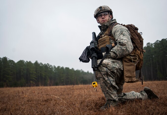 Airman Taylor Queen, 2nd Combat Camera Squadron photojournalist, provides rear security for a tactical movement patrol during the Ability to Survive and Operate exercise Jan. 14, 2014, at North Auxiliary Air Field, S.C. The 1st Combat Camera Squadron located at Joint Base Charleston, S.C., hosted the Ability to Survive and Operate Exercise from Jan. 6 through 17. (U.S. Air Force photo/ Senior Airman Dennis Sloan)