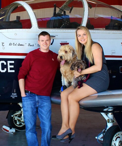 Laura Rice, right, her husband, Capt. Lee Rice, and their 7-year-old Schnoodle, Maverick. (Courtesy photo/ Andi Adams)