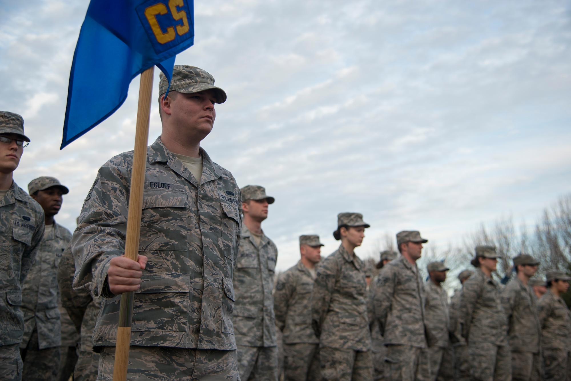 Airman 1st Class Janson Egloff, 628th Communications Squadron network administrator, holds the 628th CS guidon during a Retreat ceremony Jan. 21, 2014, at Joint Base Charleston – Air Base, S.C. The Retreat ceremony is coordinated so the playing of the National Anthem and the lowering of the American flag are completed at the same time. (U.S. Air Force photo/Tech. Sgt. Rasheen Douglas)