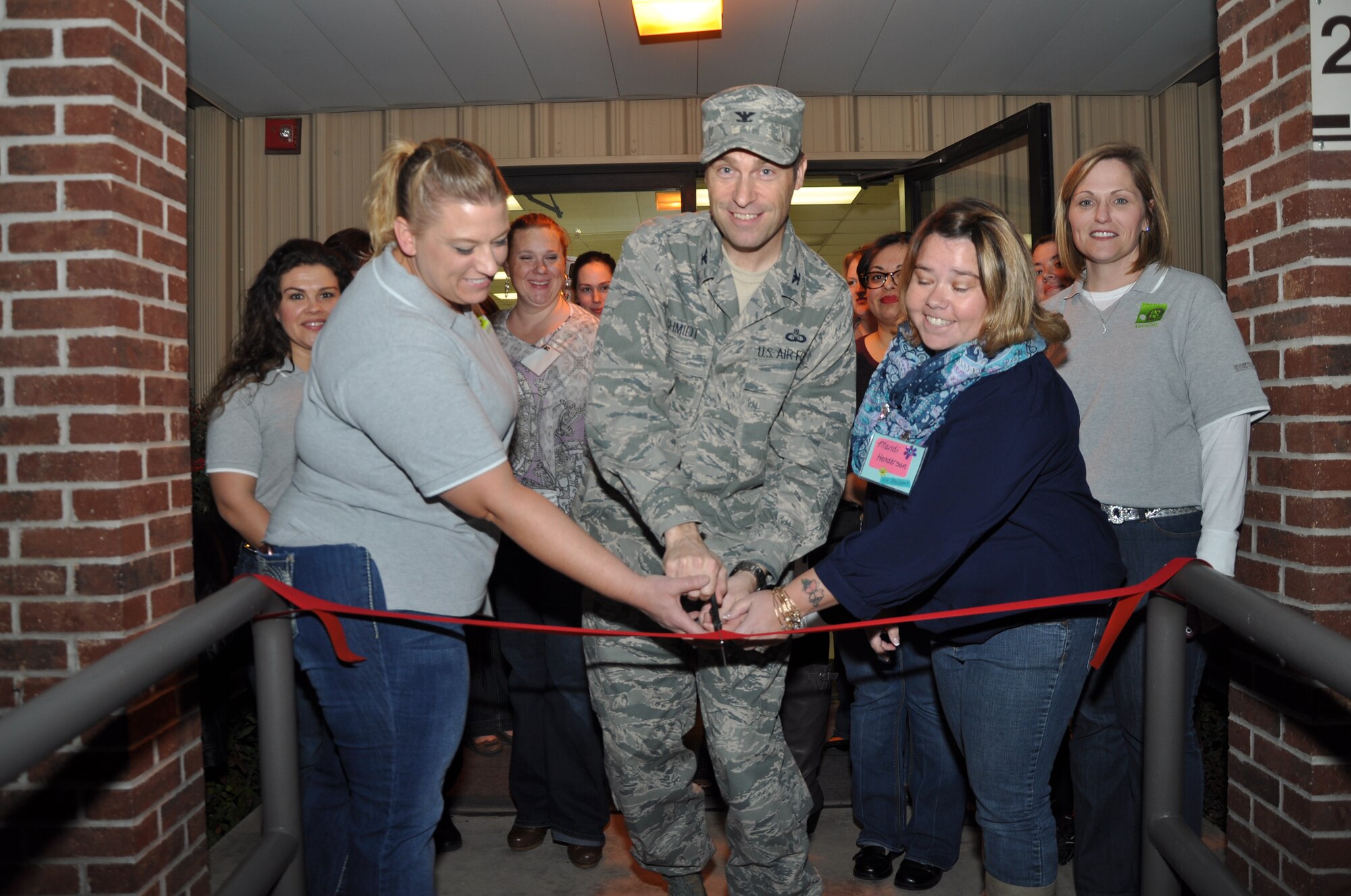 GOODFELLOW AIR FORCE BASE, Texas – Col. Thomas Schmidt, 17th Training Wing Vice Commander, cuts the ribbon to the SAMS Thrift Store with Goodfellow Combined Spouses’ Club members during the grand opening Jan. 16. The GCSC was founded to support and improve the base by building a strong support network, and to promote a sense of community amongst Team Goodfellow spouses. (U.S. Air Force photo/ Airman 1st Class Breonna Veal)