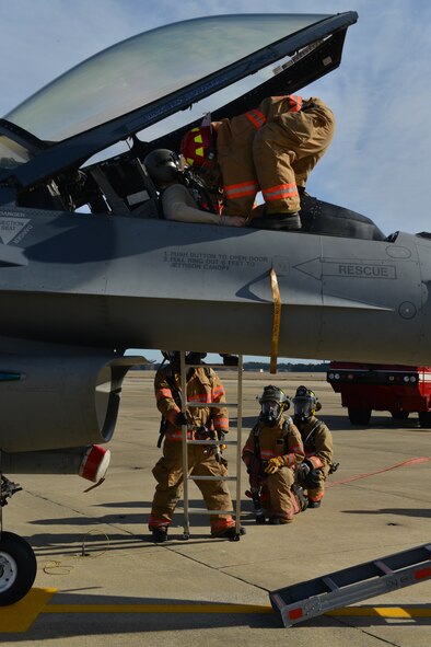 U.S. Air Force Staff Sgt. Darin Meek 20th, Civil Engineer Squadron firefighter, picks up a simulated pilot out of an F-16 Fighting Falcon at Shaw Air Force Base, S.C., Jan. 13, 2014.  Meek along with Senior Airman Romoan Loyd, Senior Airman Brandon Young and Senior Airman Leonard Butler, all 20th CES firefighters, were participating in an aircrew extraction exercise during an operational readiness exercise. (U.S. Air Force photo by Airman 1st Class Jensen Stidham/Released)