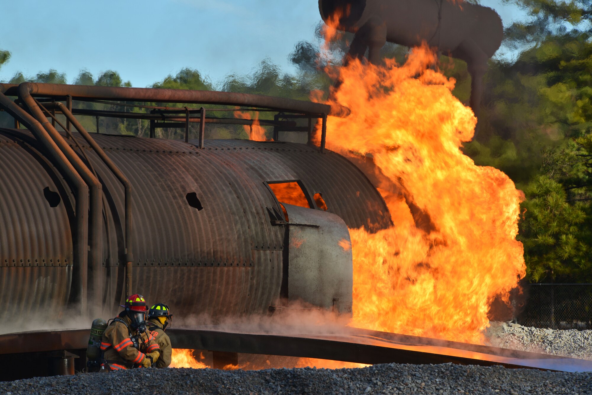 [From left] U.S. Air Force Staff Sgt. Alex Vazquez, 20th Civil Engineer Squadron firefighter, and Senior Airman Leonard Butler, 20th Civil Engineer Squadron firefighter, extinguish a controlled aircraft fire at Shaw Air Force Base, S.C., Jan. 13, 2014. Vazquez and Butler along with other 20th CES firefighters, were training with live fire during a firefighting exercise as part of an operational readiness exercise. (U.S. Air Force photo by Airman 1st Class Jensen Stidham/Released)