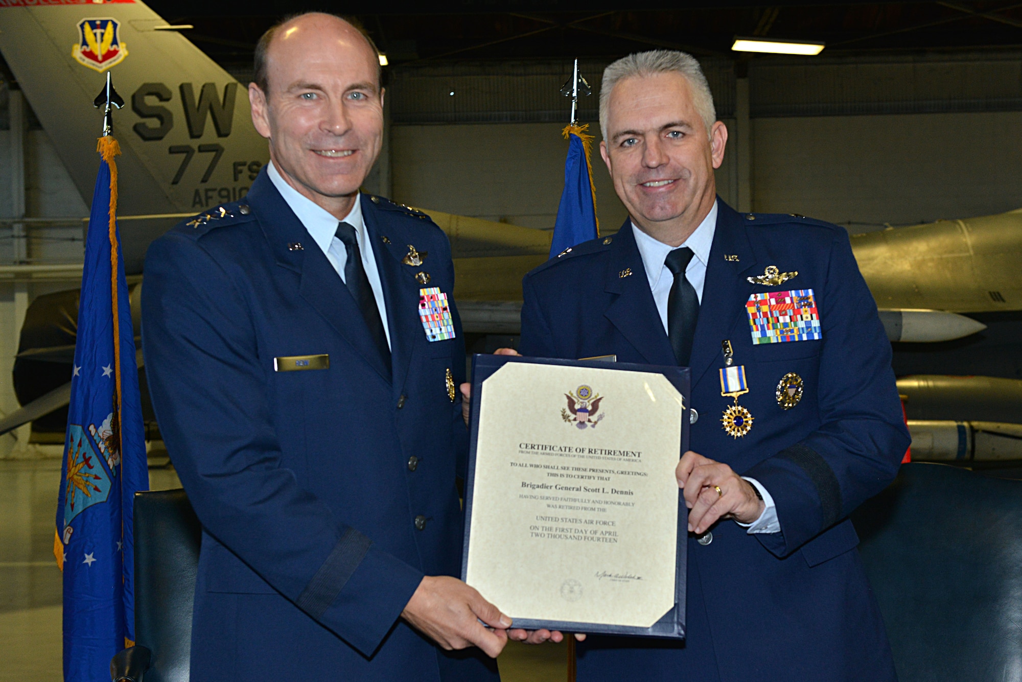 [From left] U.S. Air Force retired Lt. Gen. Bill Rew, presents Brig. Gen. Scott Dennis, U.S. Air Forces Central Command assistant deputy commander with his certificate of retirement at Shaw Air Force Base, S.C Jan. 17, 2014. More than 400 family, friends and fellow Airmen gathered together to celebrate Dennis’ 28-year career in the Air Force. (U.S. Air Force photo by Airman 1st Class Jensen Stidham/Released)
