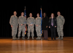 (Left) Col. Darren Hartford, 437th Airlift Wing commander, and (right) Chief Master Sgt. David Wade, 437th AW chief standing in for Chief Master Sgt. Shawn Hughes, 437th AW command chief, stand with the 437th AW Quarterly Award Winners during the 437th Quarterly Awards ceremony Jan. 16, 2014, at Joint Base Charleston – Air Base, S.C. (Left to Right) Tech. Sgt. Jessy Martin, Non-Commissioned Officer of the Quarter, Master Sgt. Eric Smathers, Senior Non-Commissioned Officer of the Quarter, Senior Airman Anna Sozzi, Airmen of the Quarter, Arevene Middleton, Category I Civilian of the Quarter and Rhonda Perry, Category II Civilian of the Quarter. Not pictured are Capt. Nicholas Miles, Company Grade Officer of the Quarter and Jon Kidder, Innovator of the Quarter. (U.S. Air Force photo/ Senior Airman Ashlee Galloway)