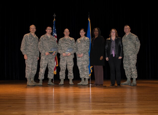 (Left) Col. Darren Hartford, 437th Airlift Wing commander, and (right) Chief Master Sgt. David Wade, 437th AW chief standing in for Chief Master Sgt. Shawn Hughes, 437th AW command chief, stand with the 437th AW Quarterly Award Winners during the 437th Quarterly Awards ceremony Jan. 16, 2014, at Joint Base Charleston – Air Base, S.C. (Left to Right) Tech. Sgt. Jessy Martin, Non-Commissioned Officer of the Quarter, Master Sgt. Eric Smathers, Senior Non-Commissioned Officer of the Quarter, Senior Airman Anna Sozzi, Airmen of the Quarter, Arevene Middleton, Category I Civilian of the Quarter and Rhonda Perry, Category II Civilian of the Quarter. Not pictured are Capt. Nicholas Miles, Company Grade Officer of the Quarter and Jon Kidder, Innovator of the Quarter. (U.S. Air Force photo/ Senior Airman Ashlee Galloway)