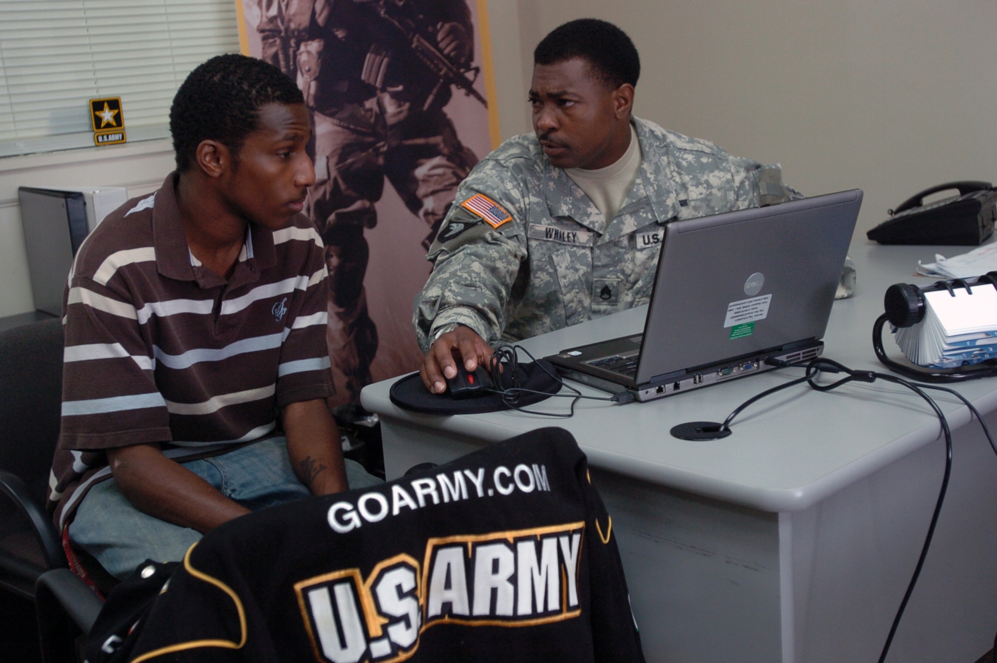 Staff Sgt. Roger L. Whaley speaks with Phillip McDonald about the possibility of becoming a journalist or X-ray technician for the Army at the U.S. Army Recruiting Station in Radcliff, Ky. Leads obtained by the Cyber Recruiting Center are often followed up by recruiters after qualifying information about the potential Soldier has been submitted.  (U.S. Army photo by Sgt. Carl N. Hudson/Released).  