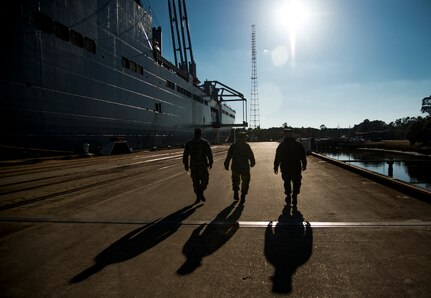 Chief Master Sgt. Mark Bronson, 628th Air Base Wing command chief, Col. Jeffrey DeVore, Joint Base Charleston commander and Master Chief Petty Officer Joseph Gardner, JB Charleston command master chief, leave the USNS Pomeroy (T-AKR 316) after a tour of the ship, Jan. 16, 2014, at Joint Base  Charleston – Weapons Station, S.C. The ship has a six-deck interior and the capacity of more than 350,000 square feet, which is equivalent to nearly seven football fields and uses the space to preposition U.S. military equipment. (U.S. Air Force photo / Senior Airman Tom Brading)