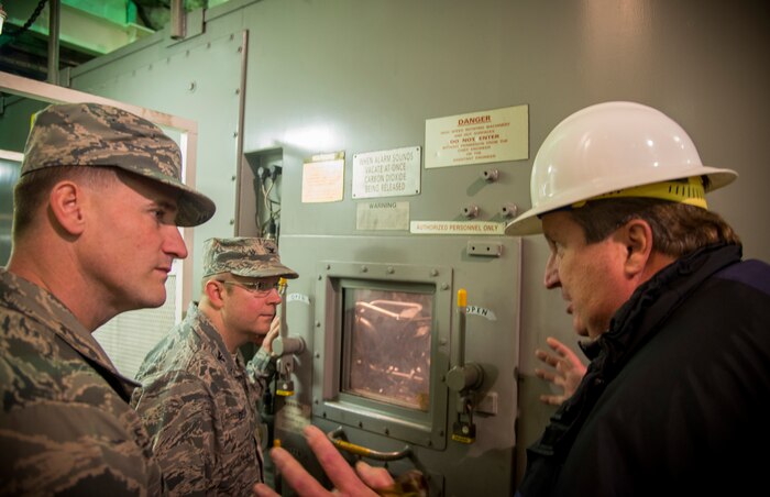 (Right) Edward Pillet, USNS Pomeroy (T-AKR 316) deck officer, gives Col. Jeffrey DeVore, Joint Base Charleston commander (center), and Chief Master Sgt. Mark Bronson, 628th Air Base Wing command chief, a tour of the USNS Pomeroy engine room, Jan. 16, 2014, at Joint Base Charleston – Weapons Station, S.C. The ship has a six-deck interior and the capacity of more than 350,000 square feet, equivalent to nearly seven football fields, and uses the space to preposition U.S. military equipment. (U.S. Air Force photo / Senior Airman Tom Brading)