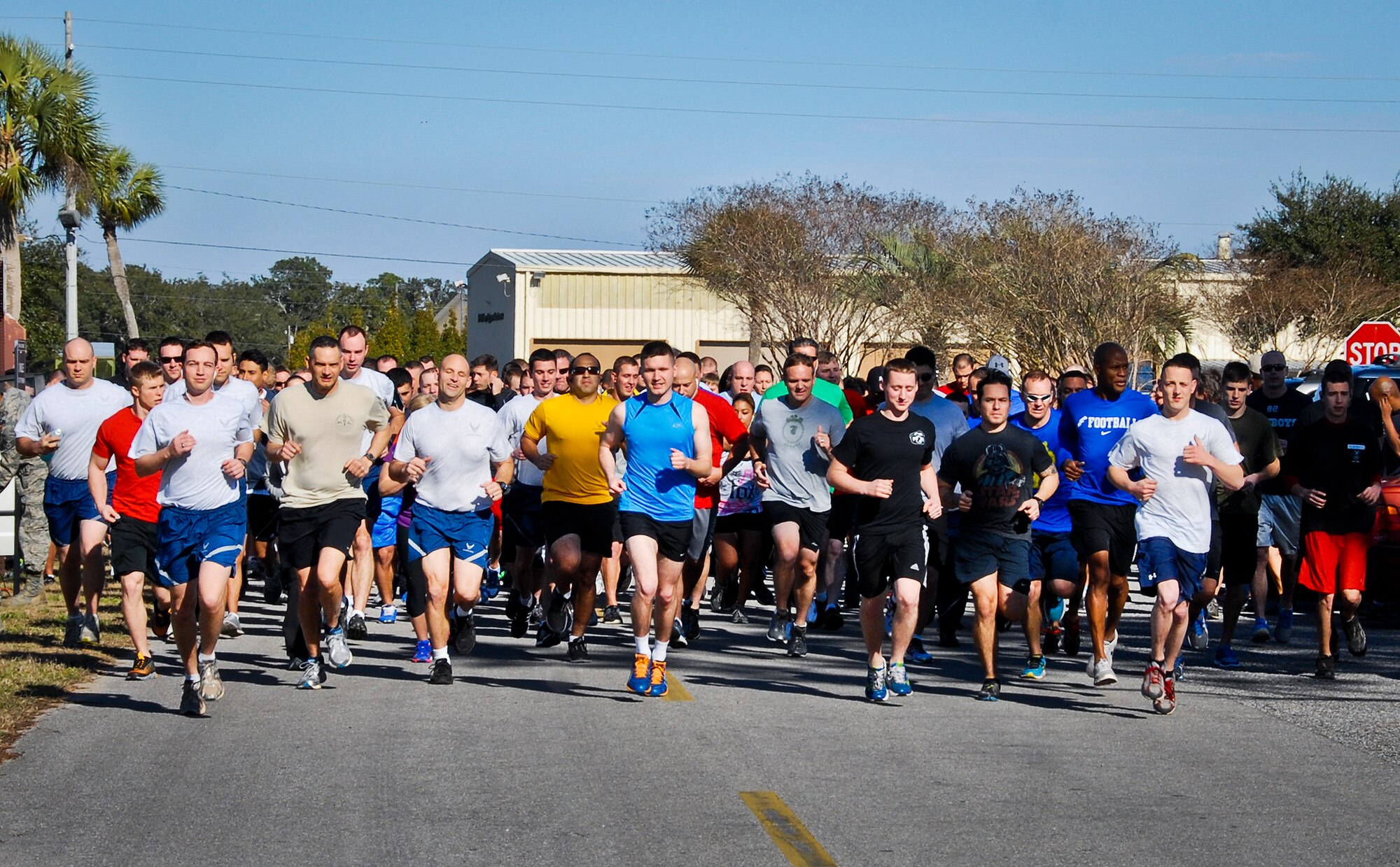 Runners take off at the Resolution Three Mile Run/Walk Jan. 17 at Eglin Air Force Base, Fla.  The race was an invitation for participants to commit or re-commit to physical fitness in 2014. (U.S. Air Force photo/Kevin Gaddie)