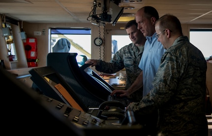 Capt. Todd Datsis, USNS Pomeroy master  (center), explains the ship’s bridge controls to Col. Jeffrey DeVore, Joint Base Charleston commander, and Chief Master Sgt. Mark Bronson, 628th Air Base Wing command chief, onboard the USNS Pomeroy (T-AKR 316) during a tour Jan. 16, 2013, at Joint Base Charleston – Weapons Station, S.C. The Pomeroy is a 950-foot-long, medium-speed, roll on/roll off cargo ship with a crew of 30 used for prepositioning U.S. military combat equipment and combat support equipment needed overseas and for resupplying U.S. armed forces with vital equipment during an international crisis. (U.S. Air Force photo / Senior Airman Tom Brading)