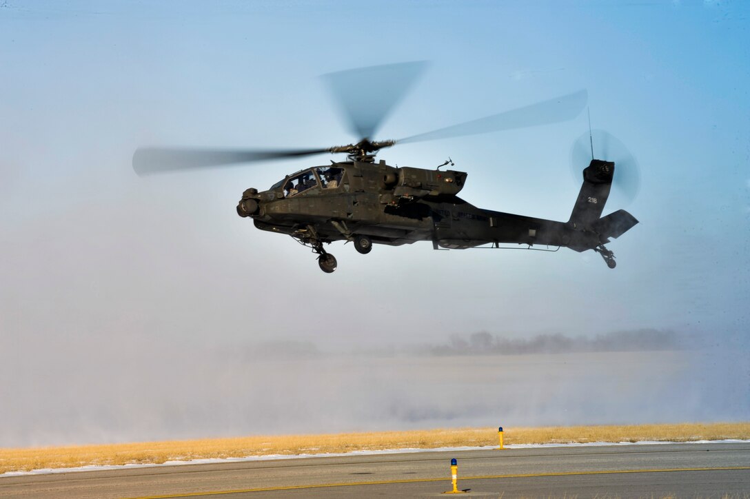 U.S. Army Chief Warrant Officer 5 Robert Moore, 1-135th Attack/Reconnaissance Battalion aviation safety officer, and Chief Warrant Officer 5 Peyton Supernaw, 1-135th ARB aviation material officer,perform environmental training at Whiteman Air Force Base, Mo., Jan. 9, 2014. This training helps pilots master landing in whiteout conditions. (U.S. Air Force photo by Airman 1st Class Keenan Berry/Released)